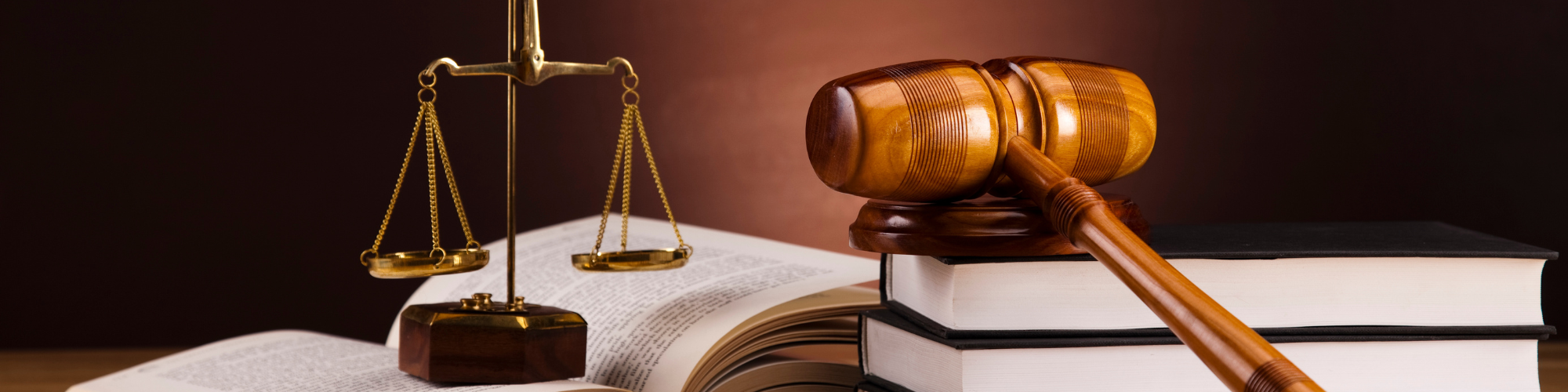 Image of justice balance and gavel sitting on top of books