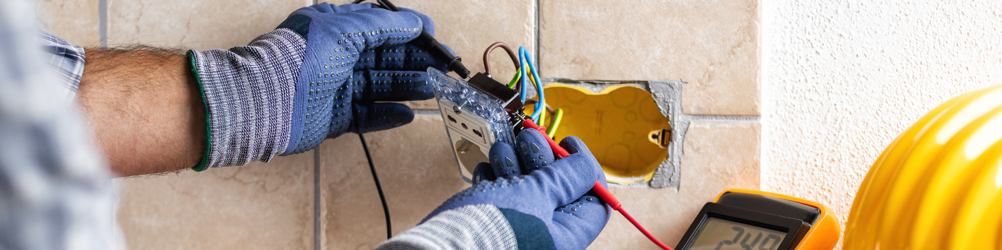 Image of a person installing electrical socket wiring