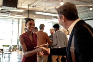 Professionals shaking hands at event