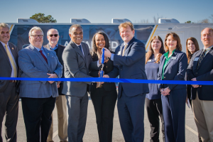 Group of people posed for ribbon cutting